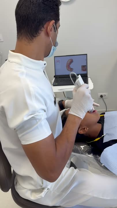 Dr. Mashaly taking a 3D scan of a patient's teeth at the clinic